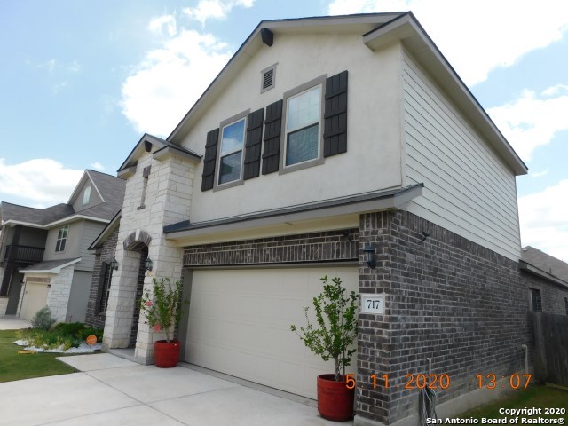 a front view of a house with potted plants