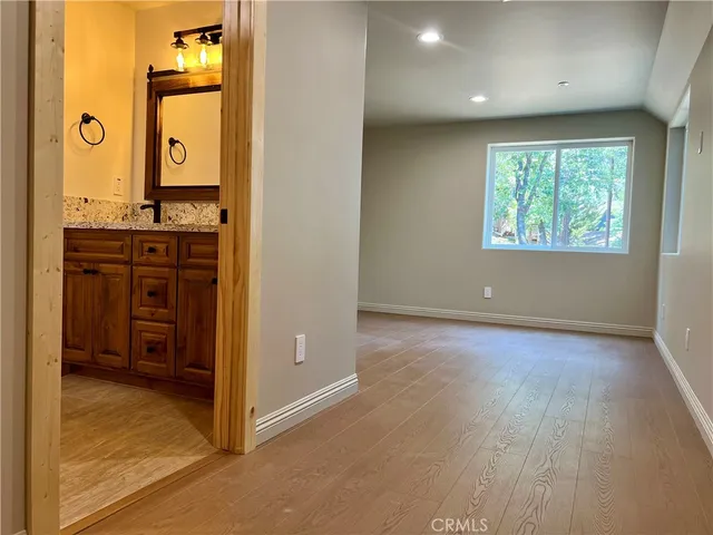an empty room with window and mirror