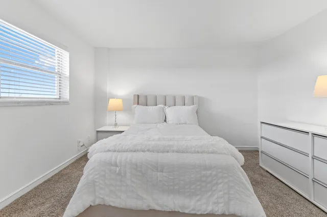 a large white bed in a white room