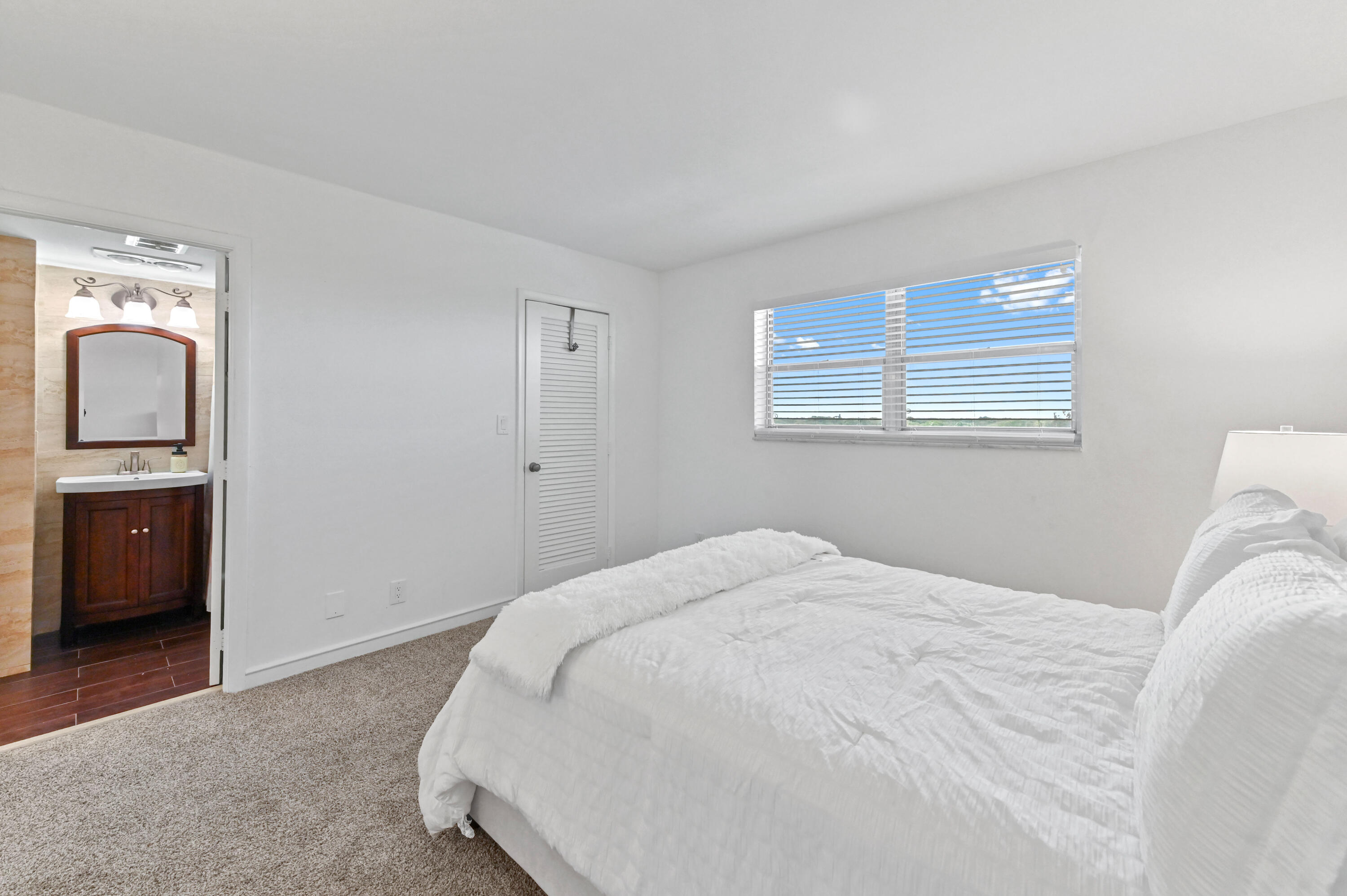 555 Northwest 4th Avenue, Unit 5070 Boca Raton, FL 33432 - Photo 13 of 29 a bedroom with a bed and a view of bedroom