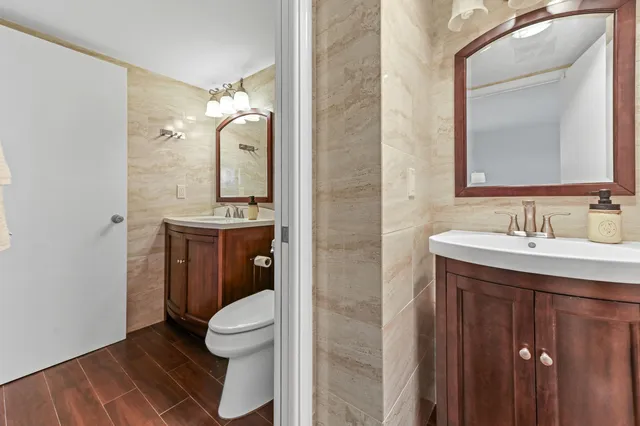 a bathroom with a toilet sink and mirror