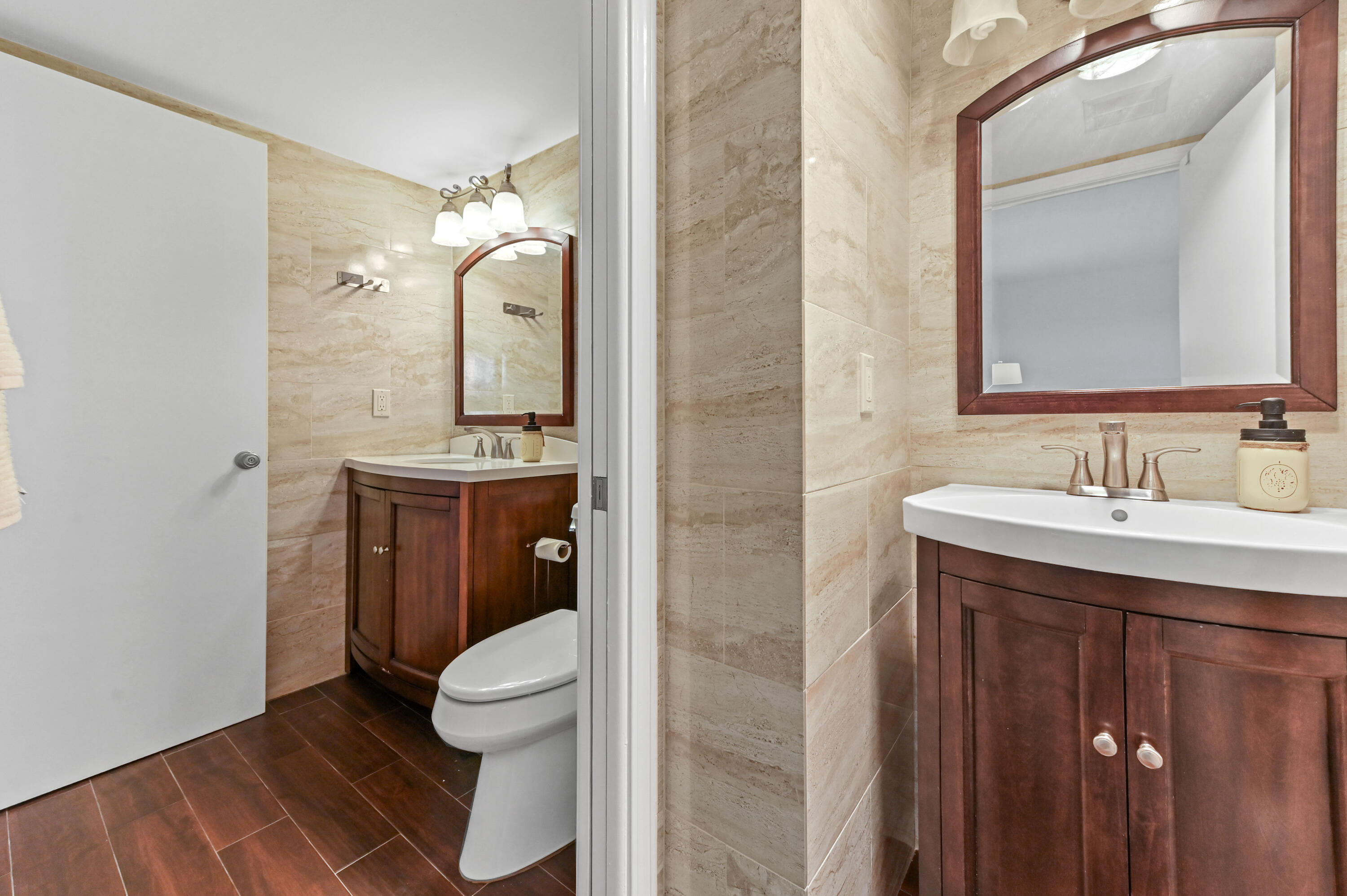 555 Northwest 4th Avenue, Unit 5070 Boca Raton, FL 33432 - Photo 14 of 29 a bathroom with a toilet sink and mirror