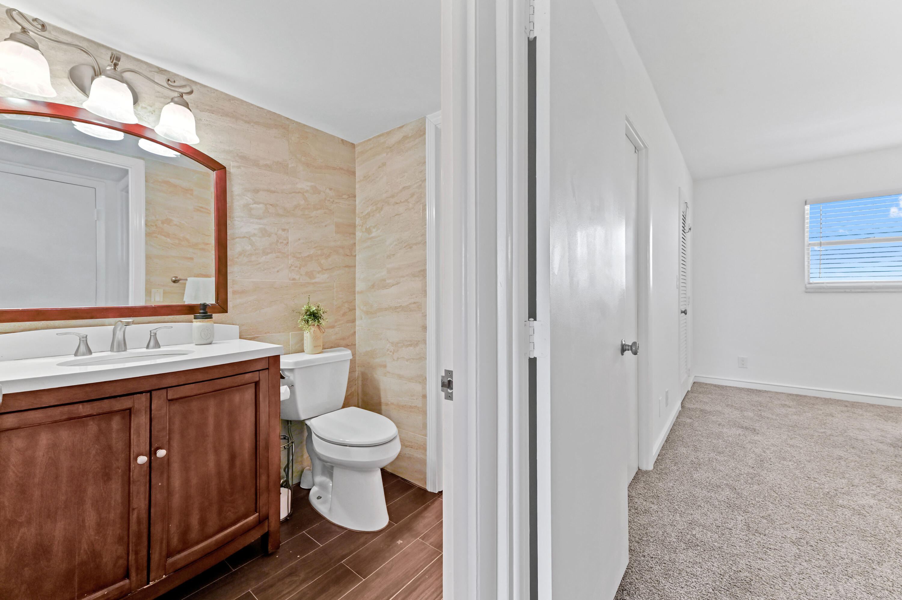 555 Northwest 4th Avenue, Unit 5070 Boca Raton, FL 33432 - Photo 17 of 29 a bathroom with a sink and toilet