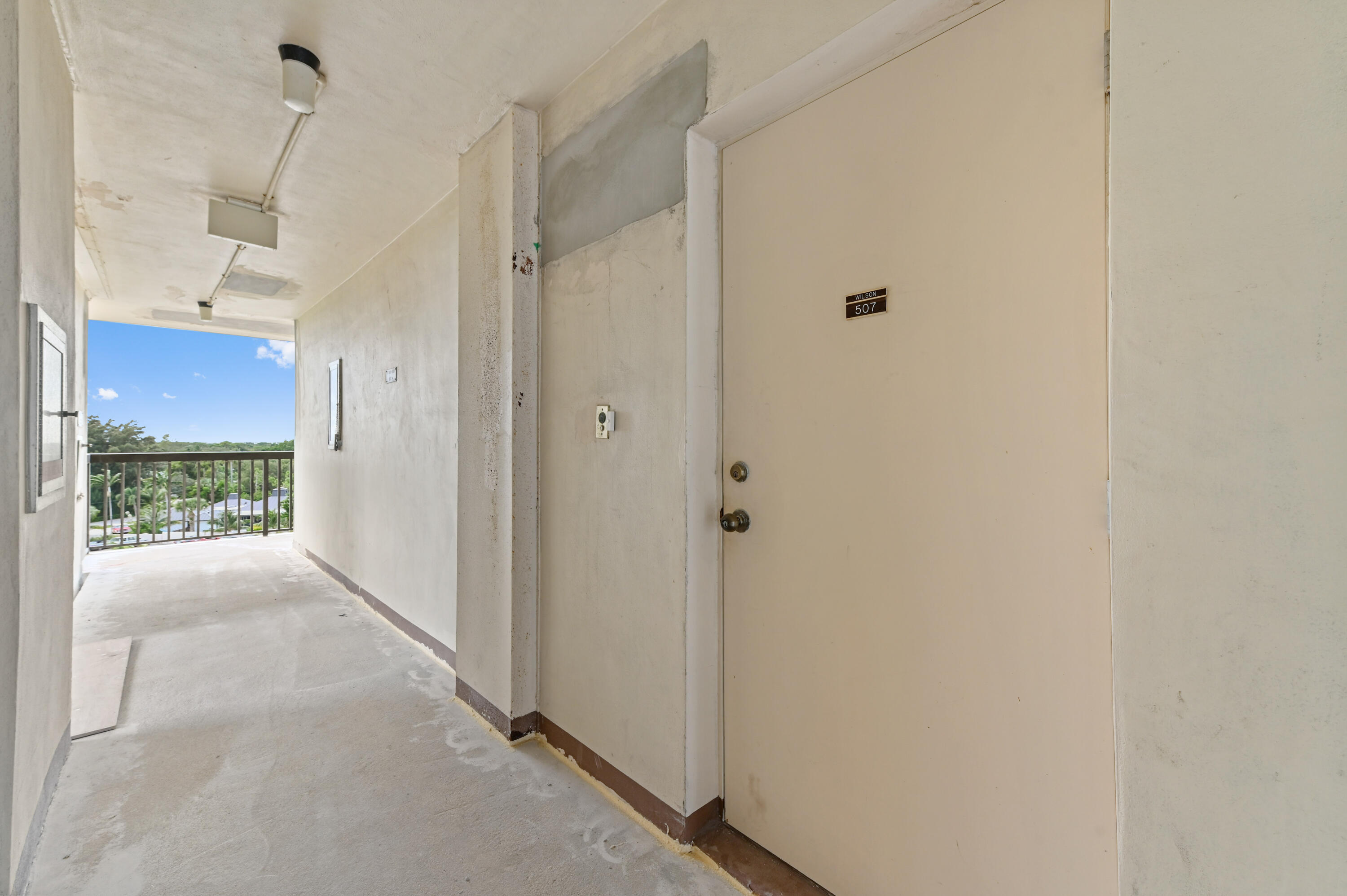 555 Northwest 4th Avenue, Unit 5070 Boca Raton, FL 33432 - Photo 20 of 29 a view of a hallway with wooden floor and a bathroom