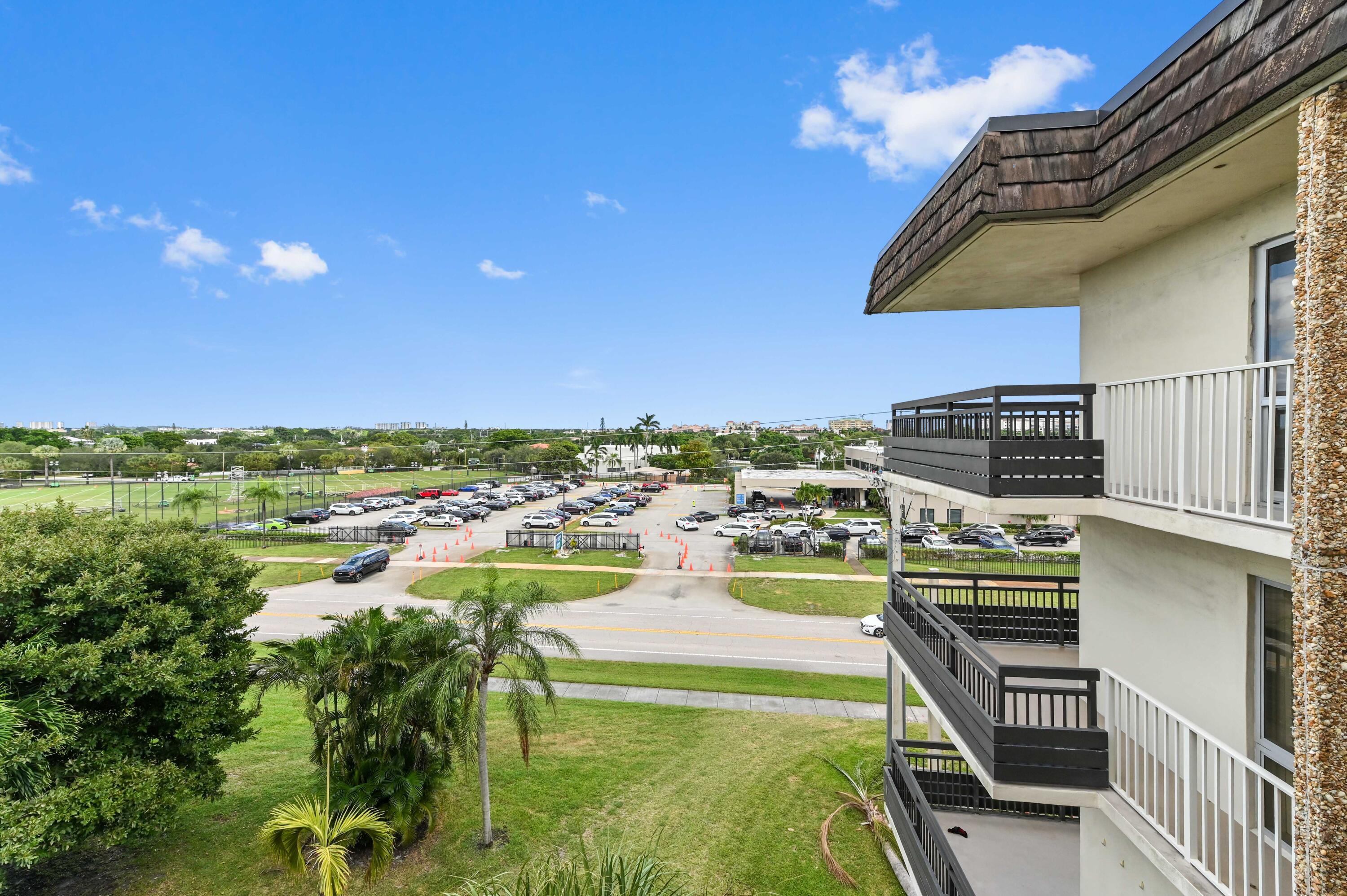 555 Northwest 4th Avenue, Unit 5070 Boca Raton, FL 33432 - Photo 2 of 29 a view of a swimming pool with outdoor seating and a yard