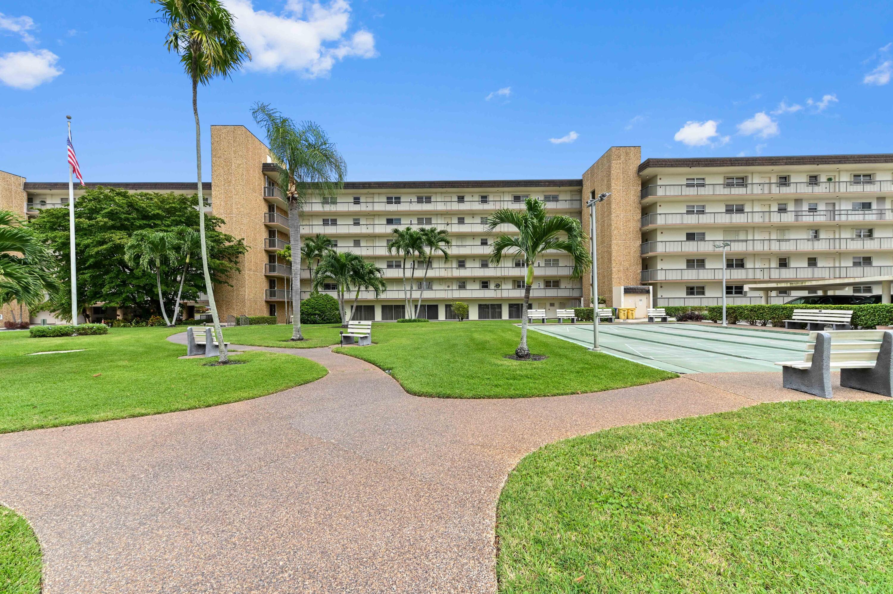 555 Northwest 4th Avenue, Unit 5070 Boca Raton, FL 33432 - Photo 21 of 29 a view of a building with a yard