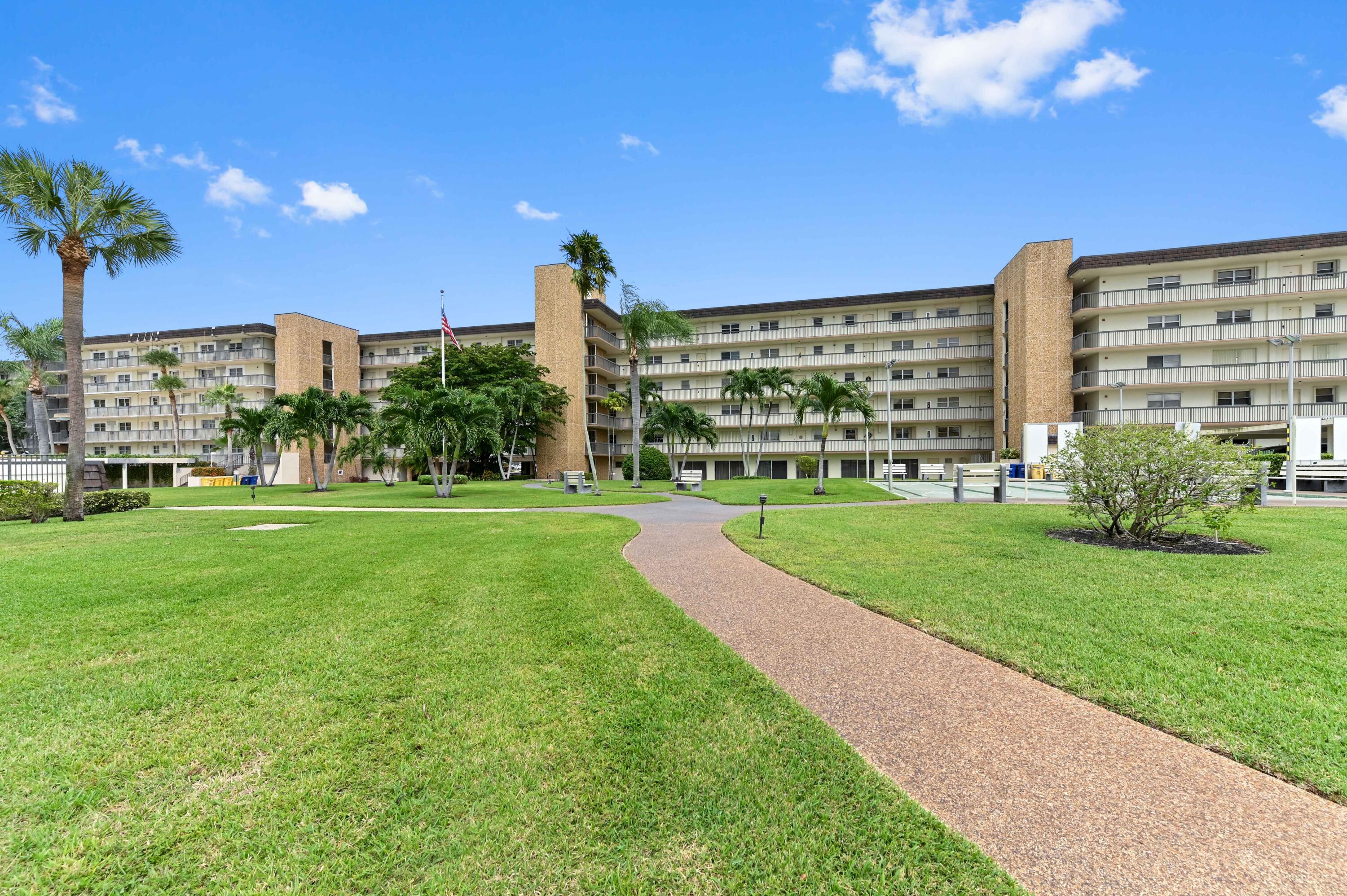 555 Northwest 4th Avenue, Unit 5070 Boca Raton, FL 33432 - Photo 22 of 29 a view of a building with a yard