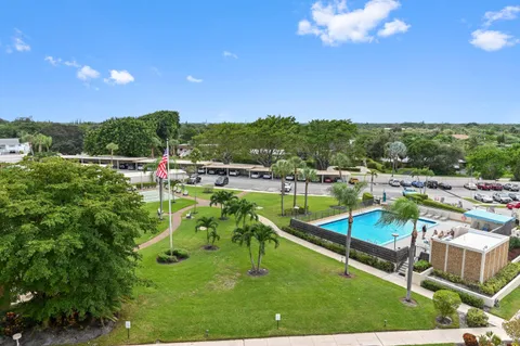 a view of a swimming pool with a yard and mountain view