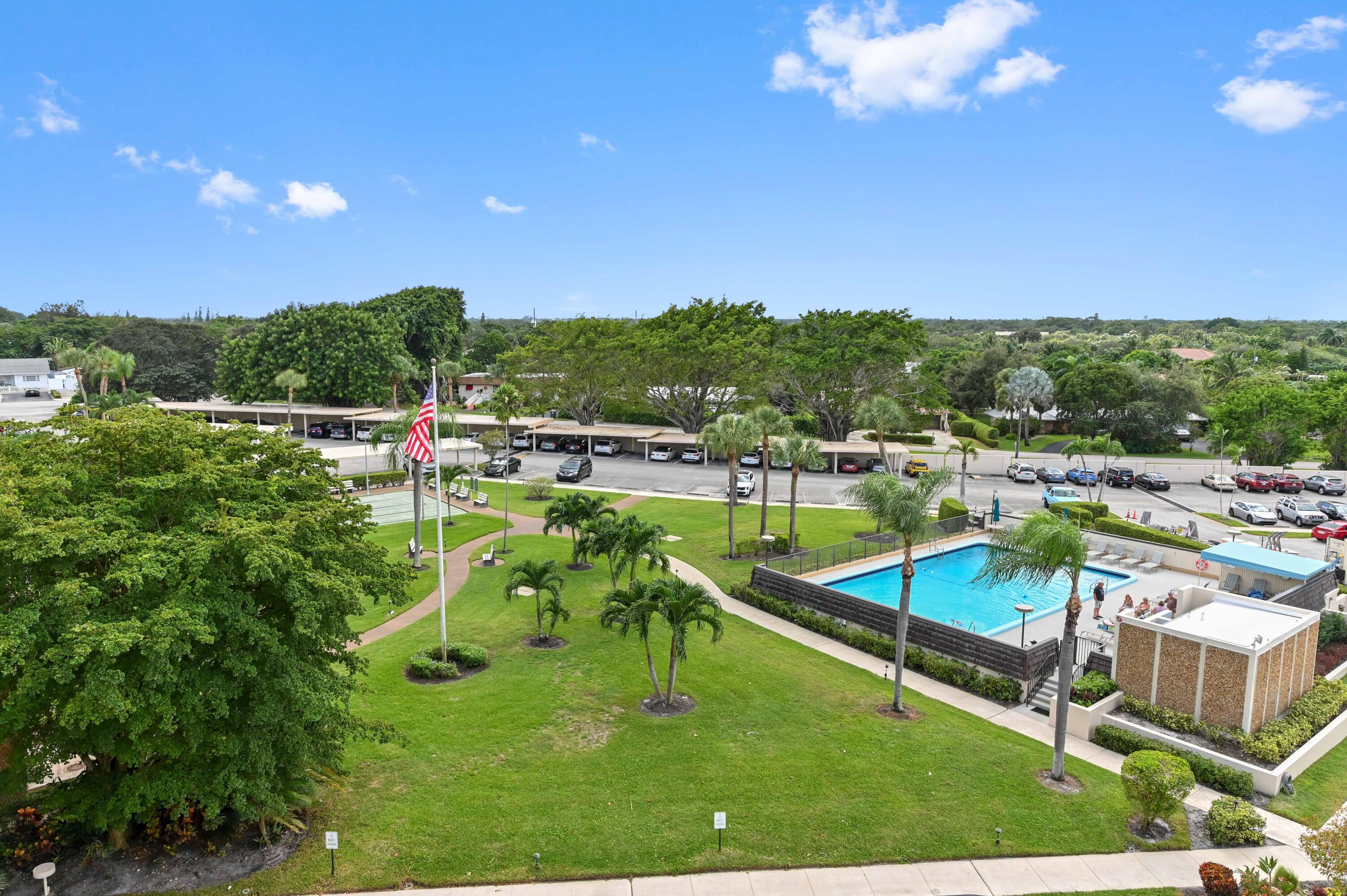 555 Northwest 4th Avenue, Unit 5070 Boca Raton, FL 33432 - Photo 23 of 29 a view of a swimming pool with a yard and mountain view