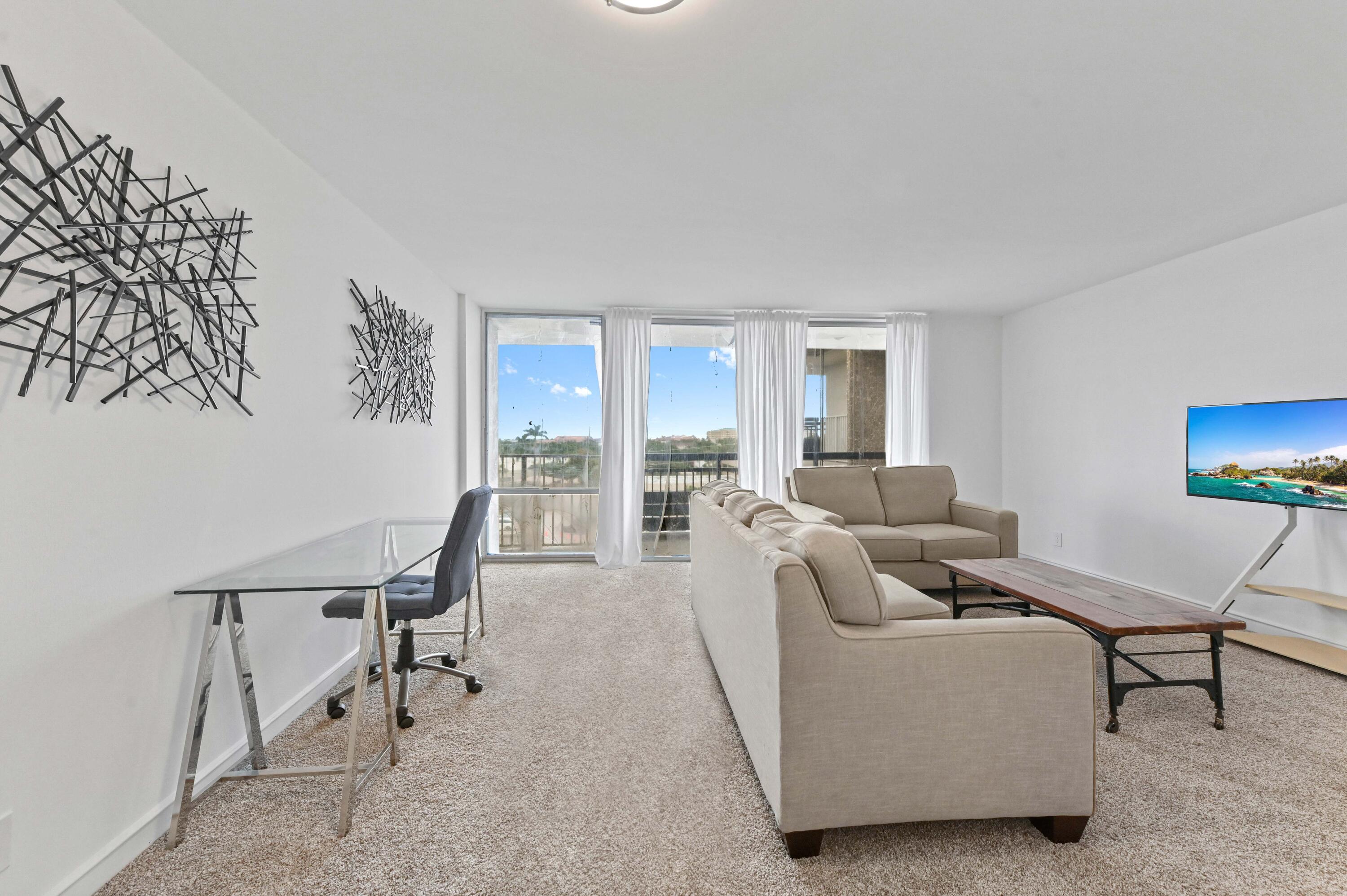 555 Northwest 4th Avenue, Unit 5070 Boca Raton, FL 33432 - Photo 4 of 29 a living room with furniture and a wooden floor