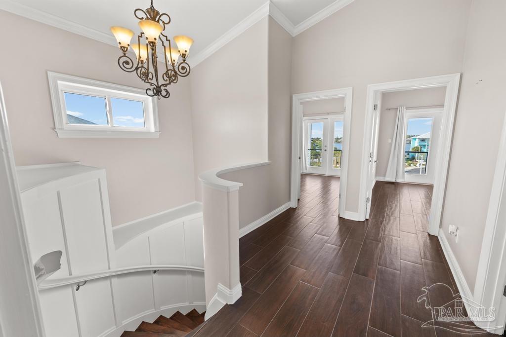 321 Gulfview Lane Perdido Key, FL 32507 - Photo 29 of 57 a view of a hallway with wooden floor and chandelier