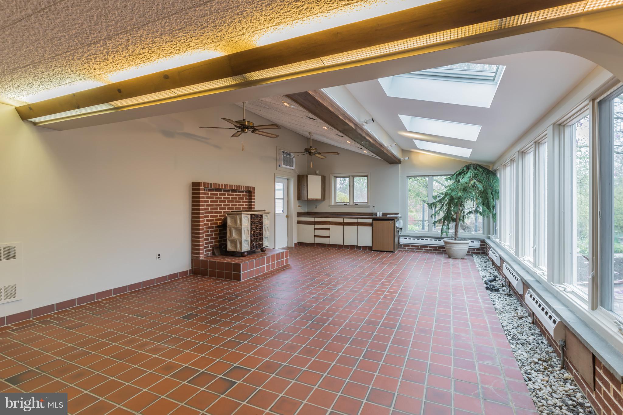 2931 Eagleville Road Eagleville, PA 19403 - Photo 22 of 46 Solarium with coal/woodburning stove.