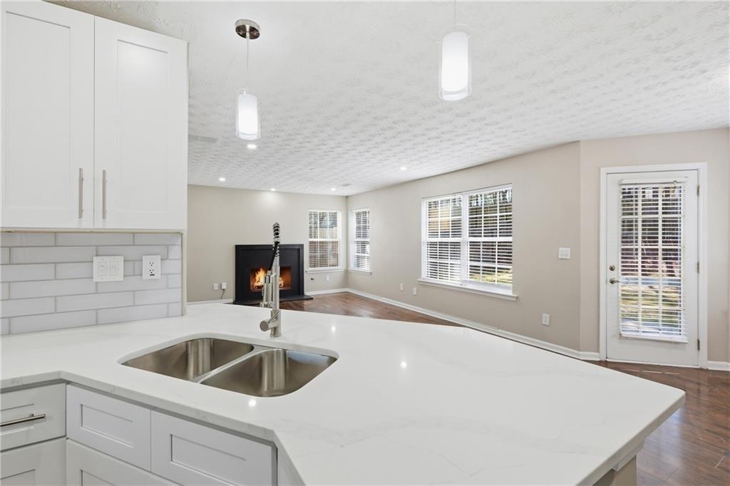 3570 Bogan Mill Road Northeast Buford, GA 30519 - Photo 6 of 31 a kitchen with a sink a faucet cabinets and a window