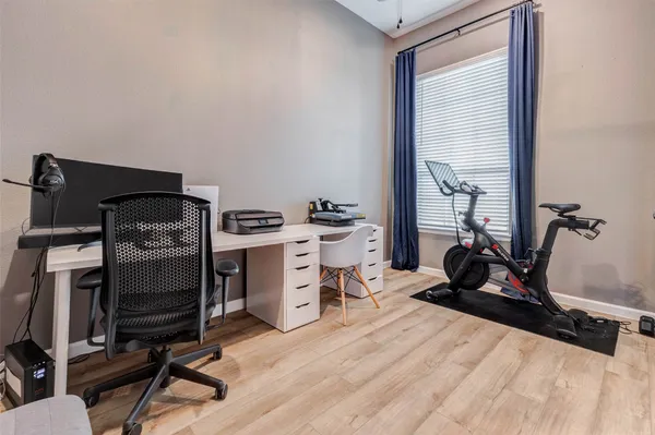 a view of a workspace with furniture and a window