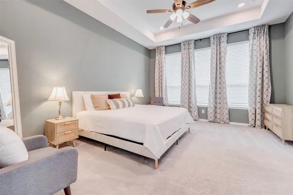 a bedroom with a bed couch and window