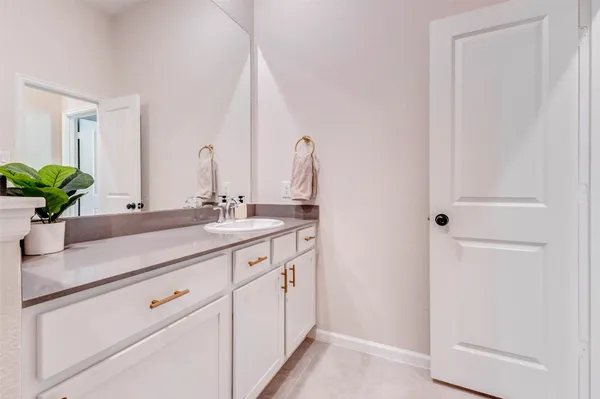a bathroom with a sink a vanity and a mirror