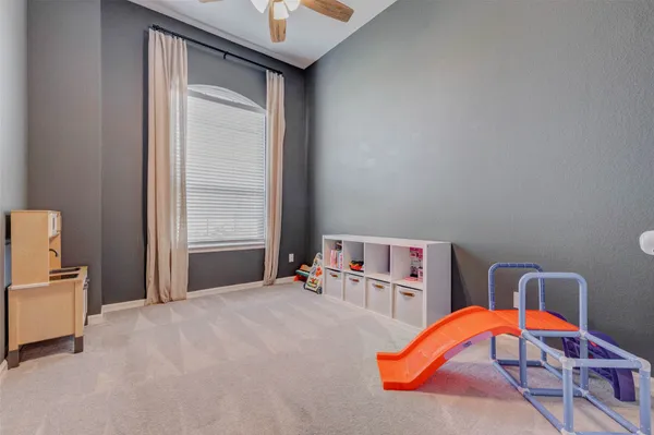 a bedroom with natural light and a bed