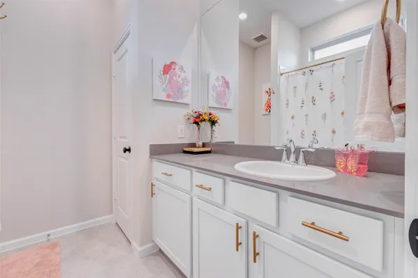 a bathroom with a granite countertop sink a mirror and a shower