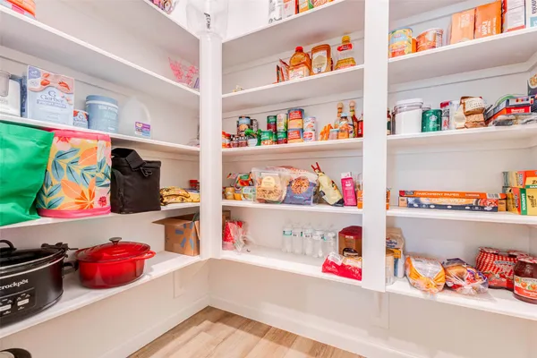 a utility room with lots of and a wooden floor