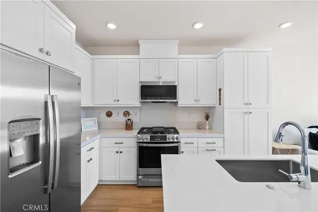 a kitchen with a refrigerator and a sink