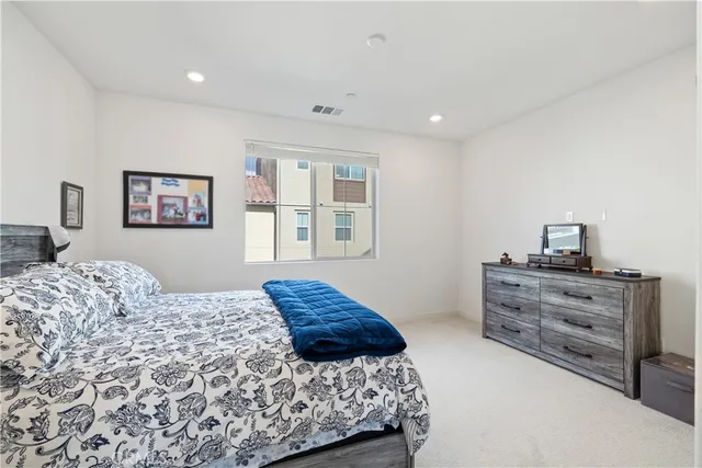 a bedroom with a bed and a couch