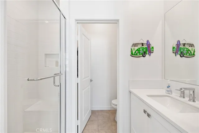 a bathroom with a granite countertop sink a toilet and a mirror