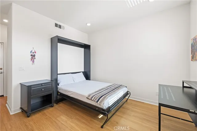 a bedroom with a bed and a dresser