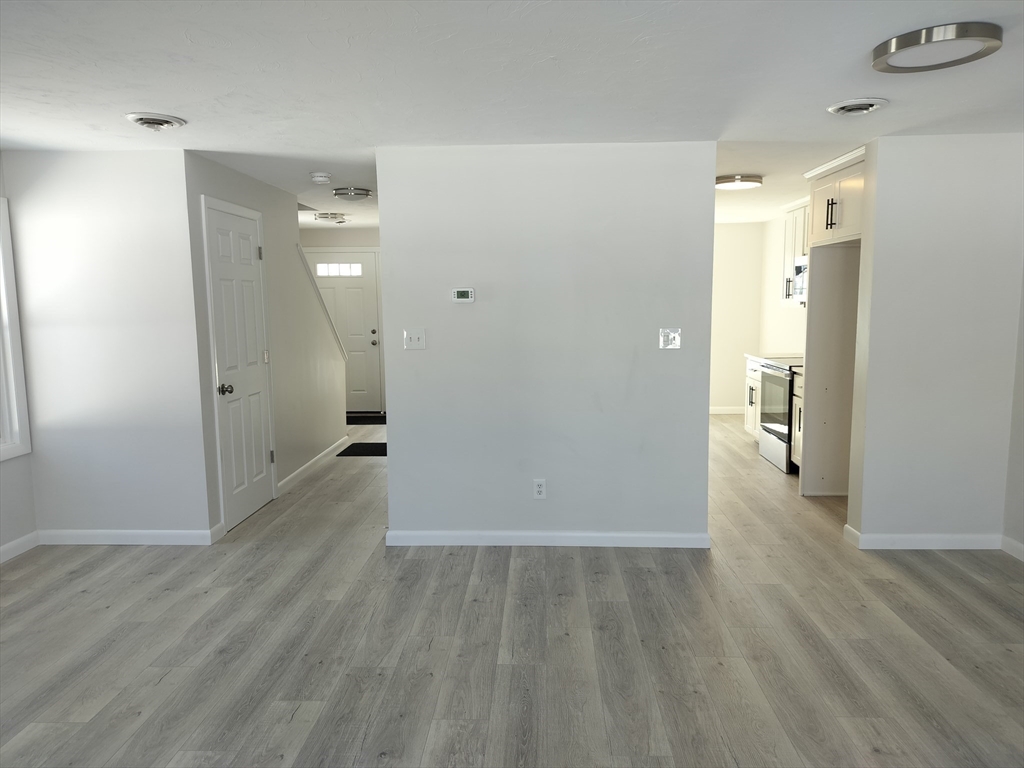 75 Warren Street West, Unit 16 Raynham, MA 02767 - Photo 12 of 22 wooden floor in an empty room