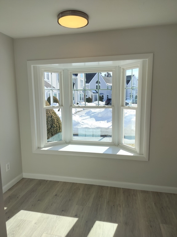 75 Warren Street West, Unit 16 Raynham, MA 02767 - Photo 13 of 22 a view of a livingroom with wooden floor and a window