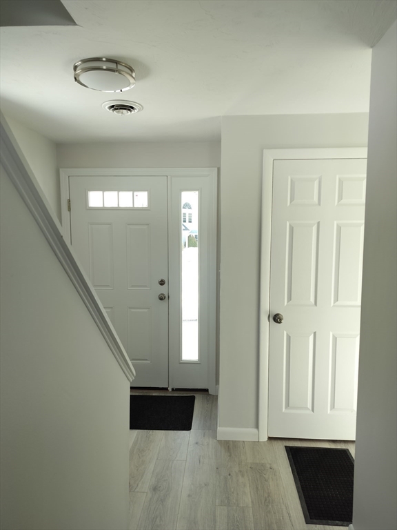 75 Warren Street West, Unit 16 Raynham, MA 02767 - Photo 15 of 22 a view of an entryway with wooden floor