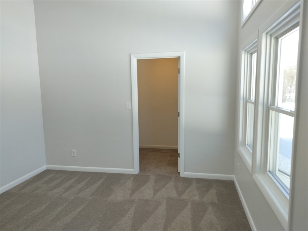 75 Warren Street West, Unit 16 Raynham, MA 02767 - Photo 20 of 22 an empty room with windows