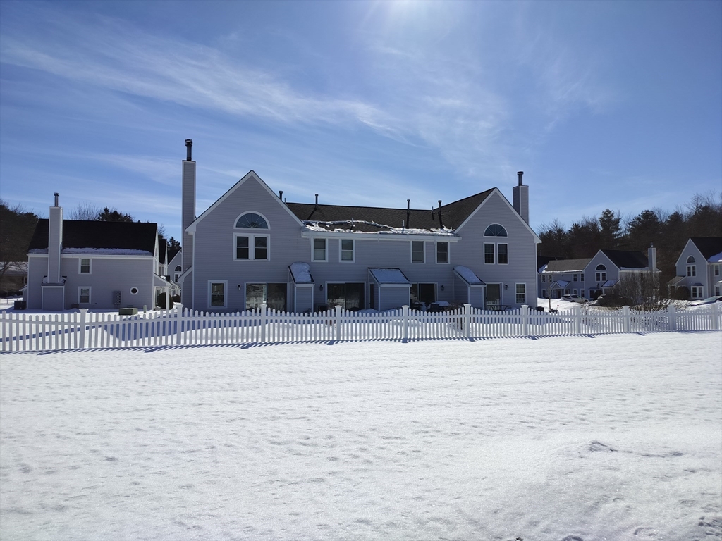 75 Warren Street West, Unit 16 Raynham, MA 02767 - Photo 21 of 22 a view of a house with a snow in a yard
