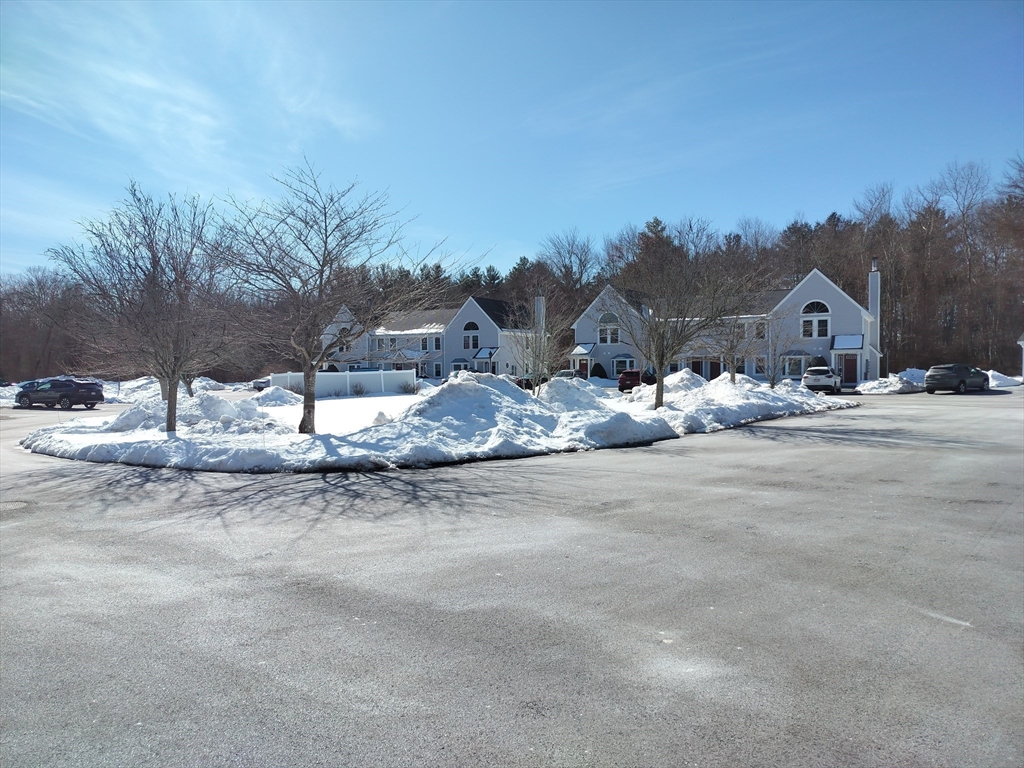 75 Warren Street West, Unit 16 Raynham, MA 02767 - Photo 22 of 22 a view of white house with a yard and covered with snow