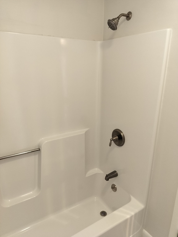 75 Warren Street West, Unit 16 Raynham, MA 02767 - Photo 8 of 22 a bathroom with a bathtub
