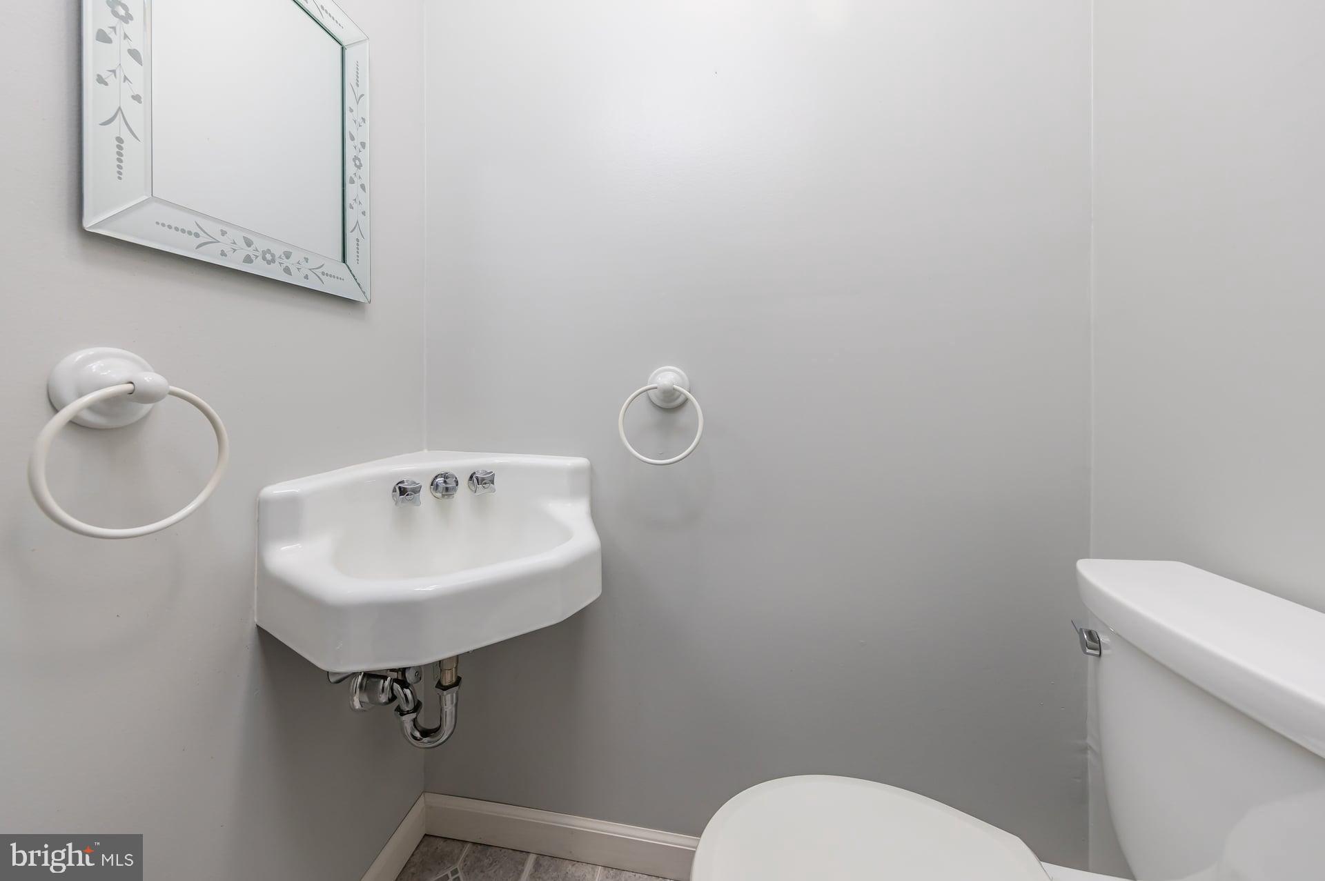 2008 Sycamore Street Haddon Heights, NJ 08035 - Photo 11 of 17 a bathroom with a sink a toilet and mirror