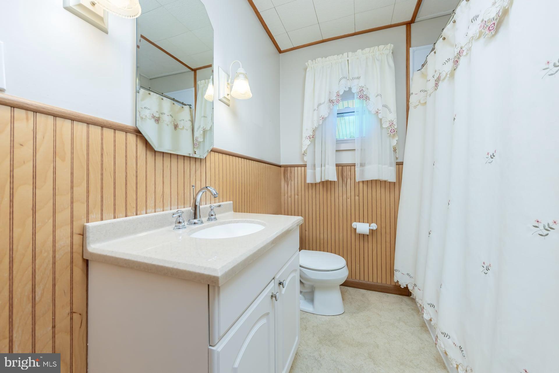 2008 Sycamore Street Haddon Heights, NJ 08035 - Photo 13 of 17 a bathroom with a sink a toilet and a mirror