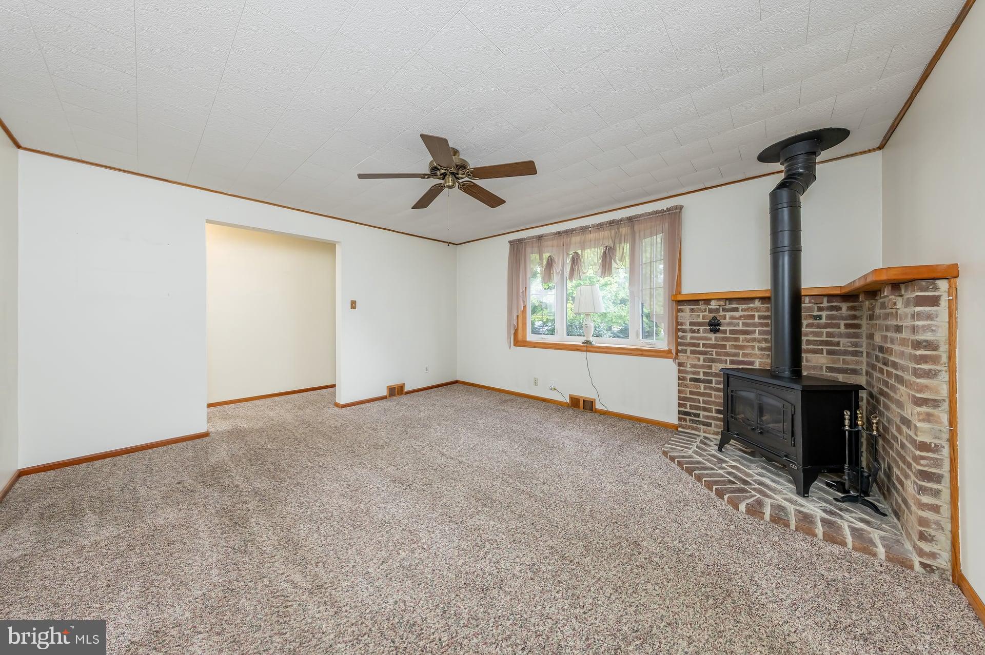 2008 Sycamore Street Haddon Heights, NJ 08035 - Photo 4 of 17 a view of an empty room with a fireplace and a window