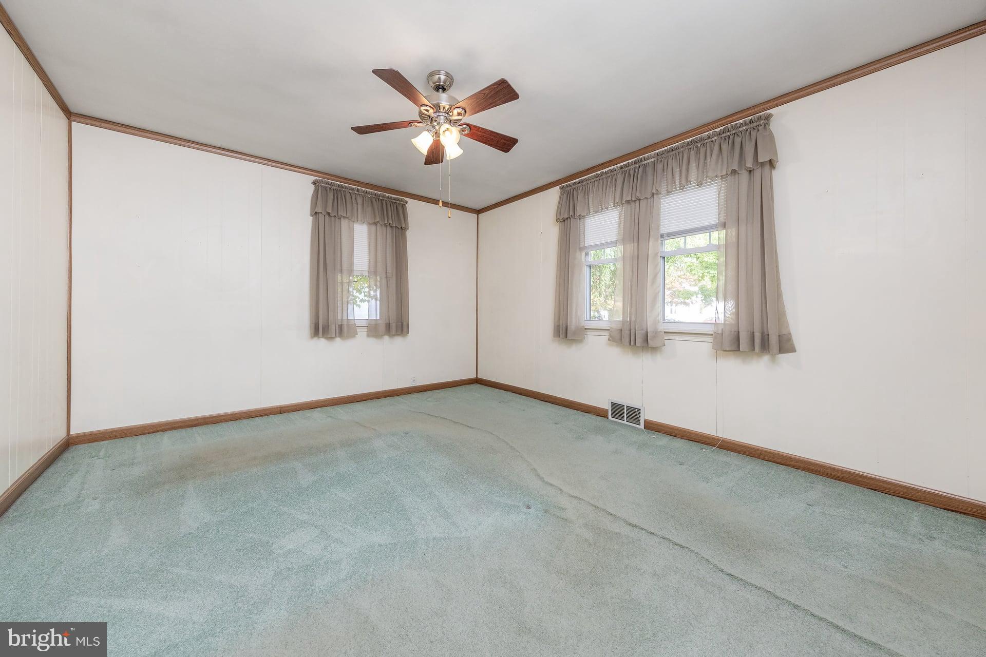 2008 Sycamore Street Haddon Heights, NJ 08035 - Photo 9 of 17 an empty room with chandelier fan and windows