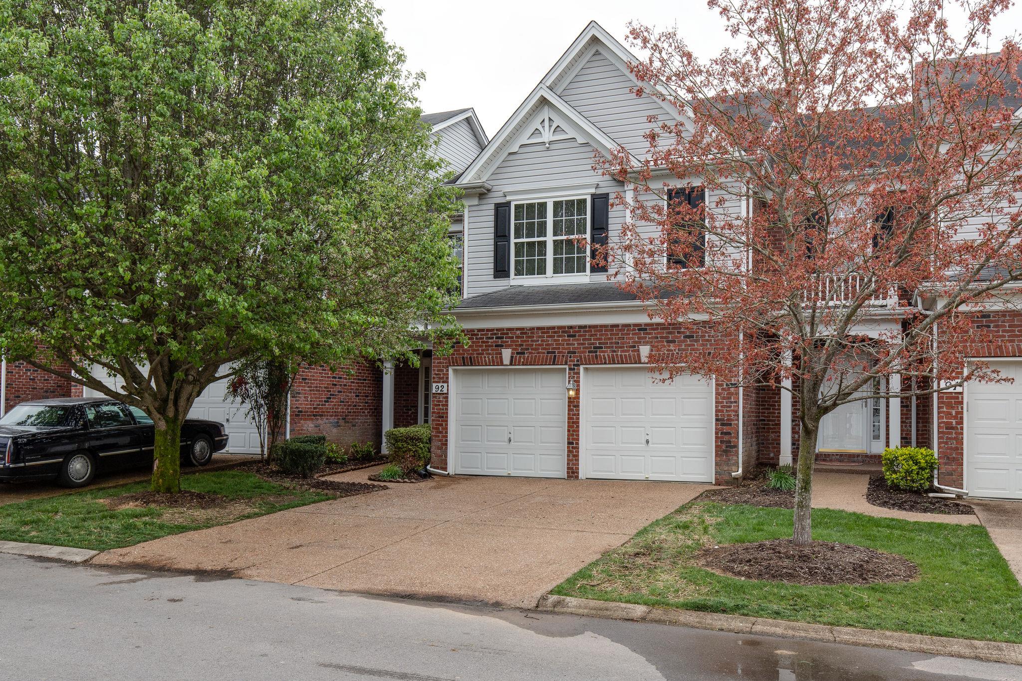 231 Green Harbor Road, Unit 92 Old Hickory, TN 37138 - Photo 1 of 30 a view of a white house with a large tree and plants
