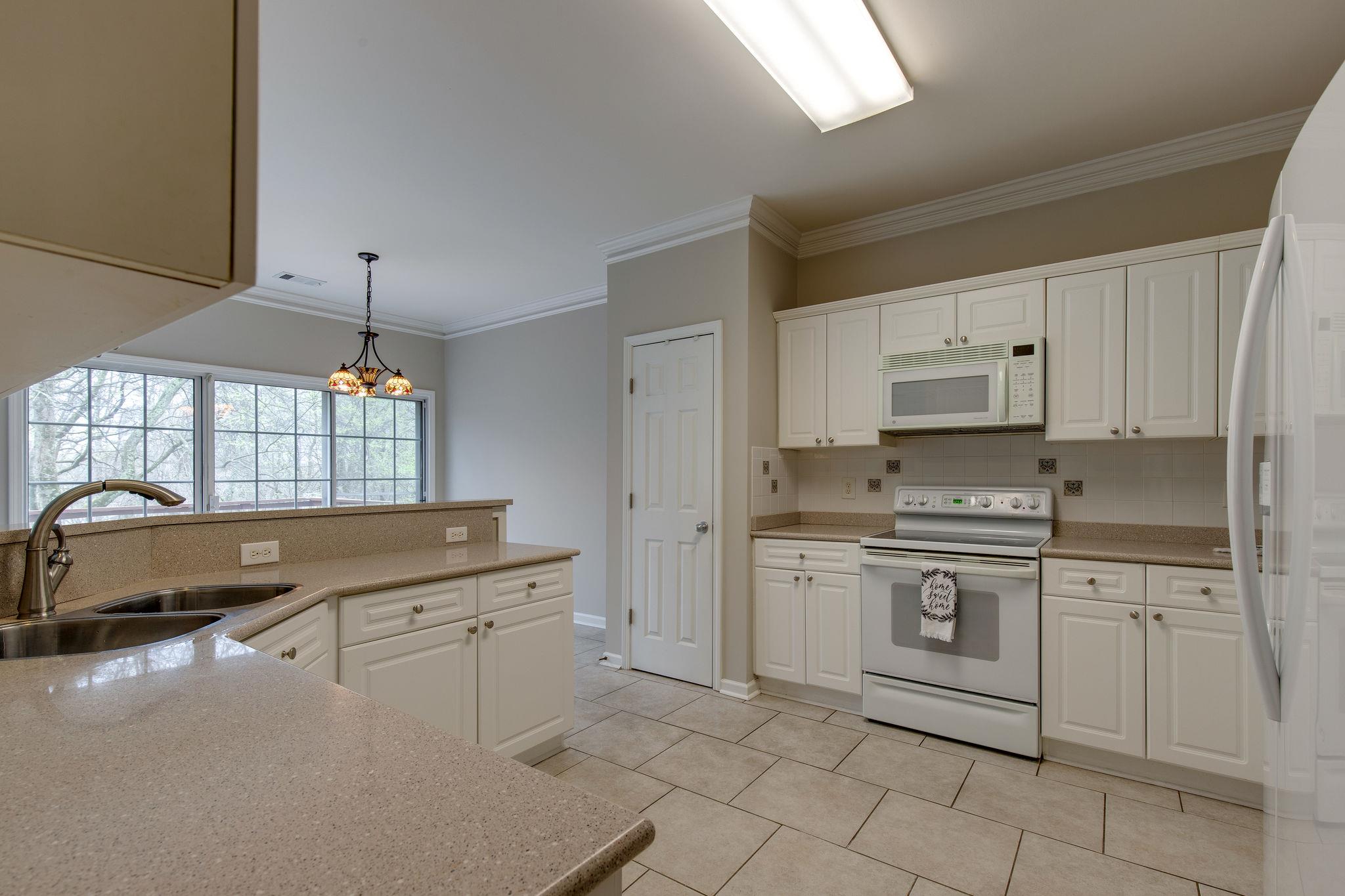 231 Green Harbor Road, Unit 92 Old Hickory, TN 37138 - Photo 14 of 30 a kitchen with white cabinets and white appliances