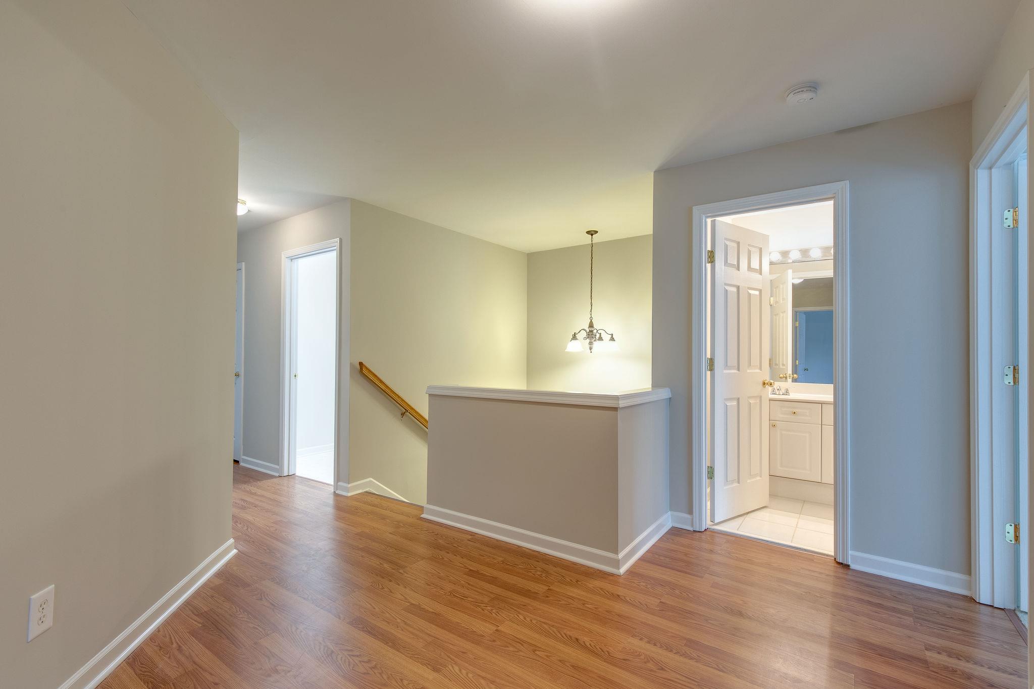 231 Green Harbor Road, Unit 92 Old Hickory, TN 37138 - Photo 18 of 30 a view of an empty room with wooden floor and a kitchen