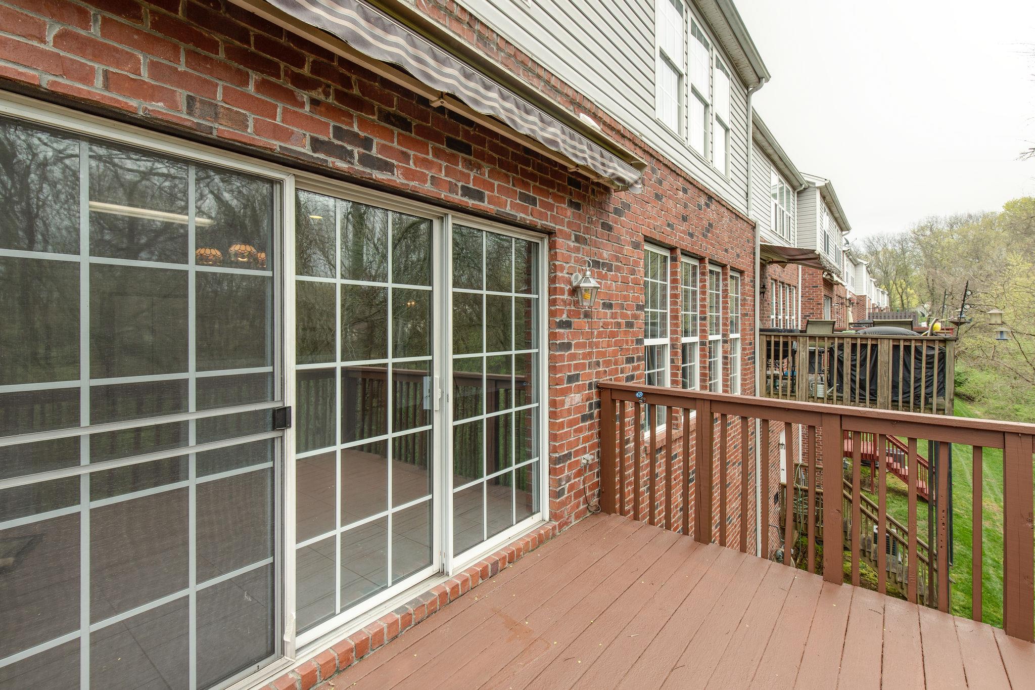 231 Green Harbor Road, Unit 92 Old Hickory, TN 37138 - Photo 27 of 30 a view of a balcony with a floor to ceiling window and wooden floor
