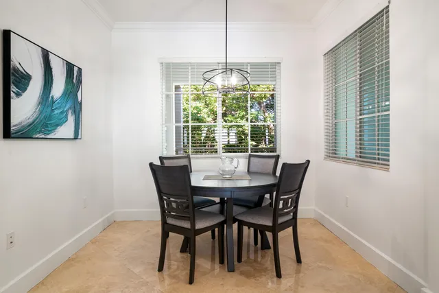 a living room with furniture and a view of kitchen