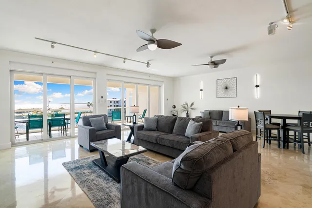 a living room with lots of furniture and a large window