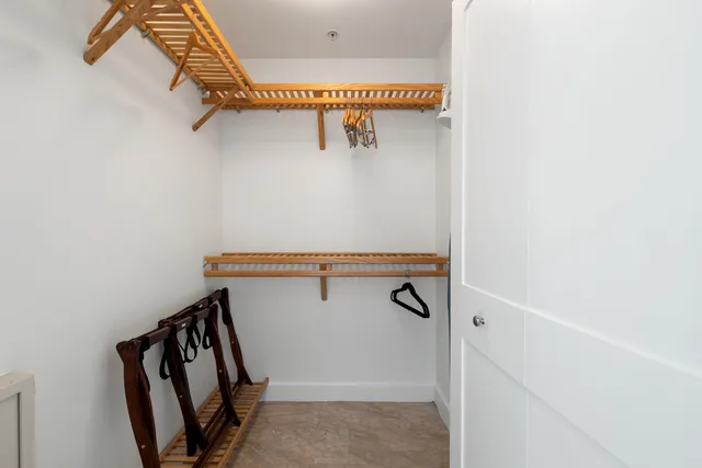 a bedroom with a bed and a lamp