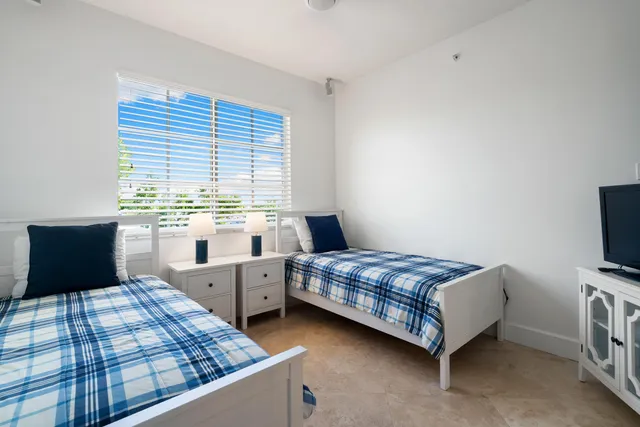 a bedroom with a bed and a lamp