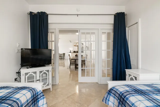 a bedroom with a bed and a television