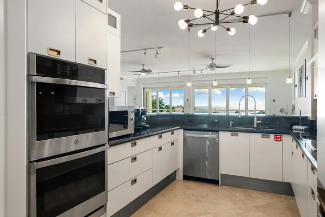 a kitchen with refrigerator cabinets and dining table