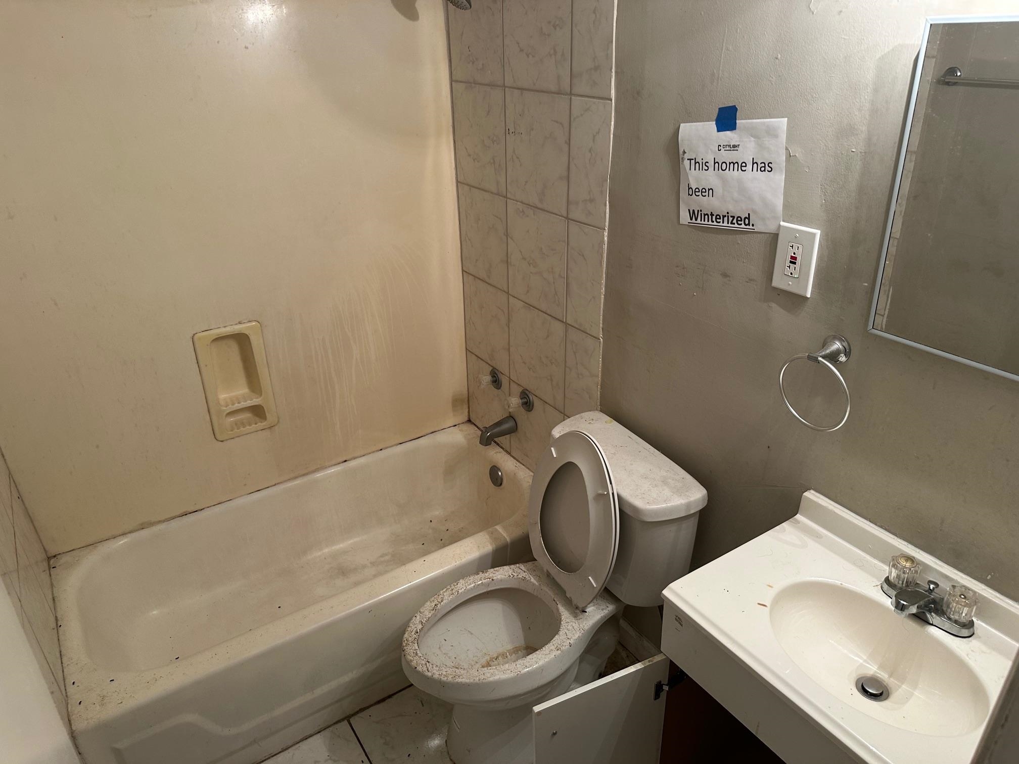 4423 Sumners Wells Road Memphis, TN 38118 - Photo 6 of 8 Full bathroom featuring tile patterned floors, tiled shower / bath, vanity, and toilet