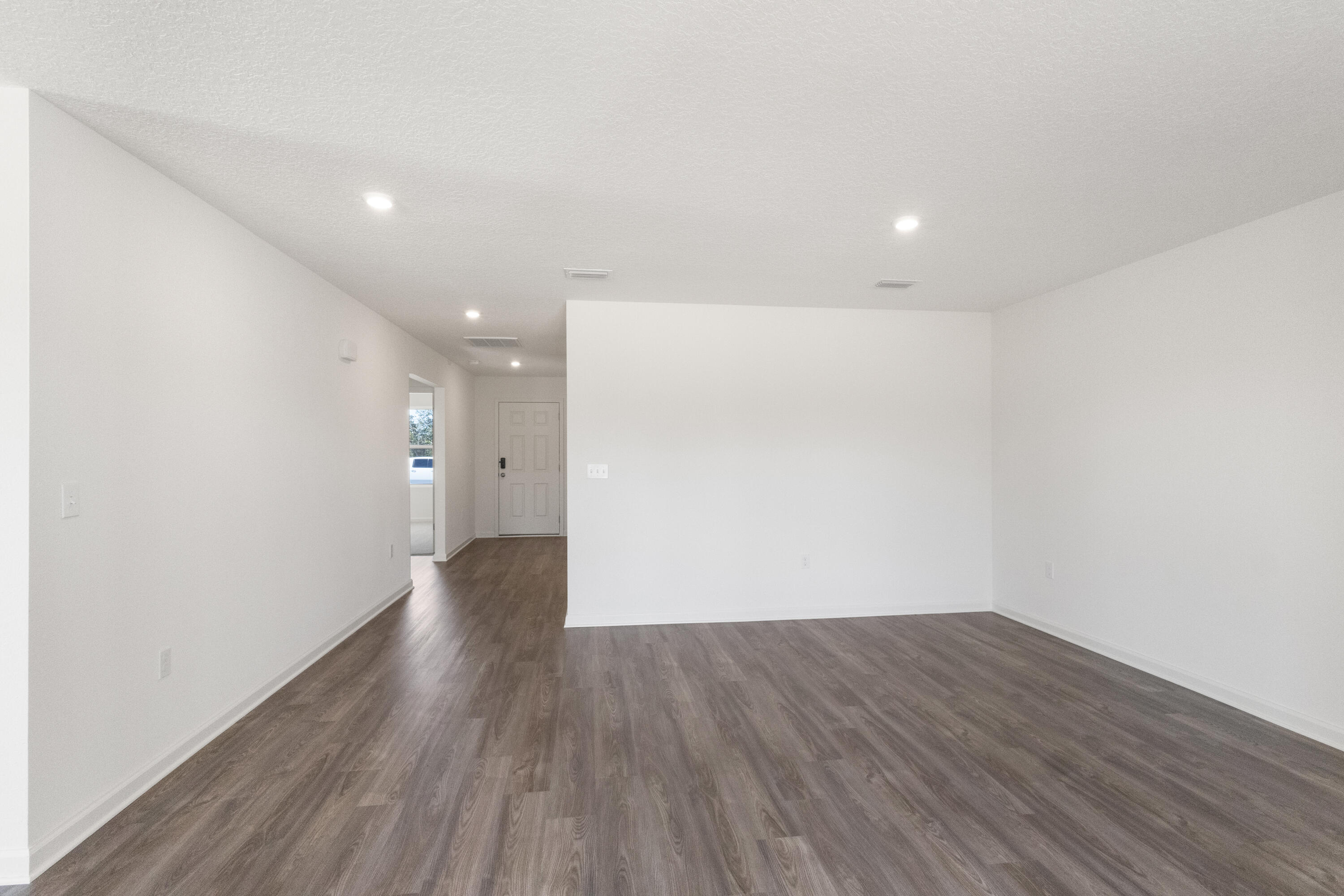 291 Cat Island Road DeFuniak Springs, FL 32433 - Photo 18 of 18 a view of an empty room with wooden floor